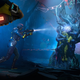 Rainbow Six Extraction operators with flashlights on the end of their guns peer into a room hosting an alien organism.